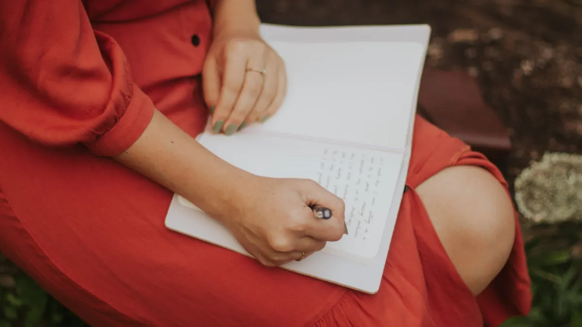 Best journaling techniques for beginners Best journaling techniques for beginners — Woman Writing in Journal Outdoors in Red Dress