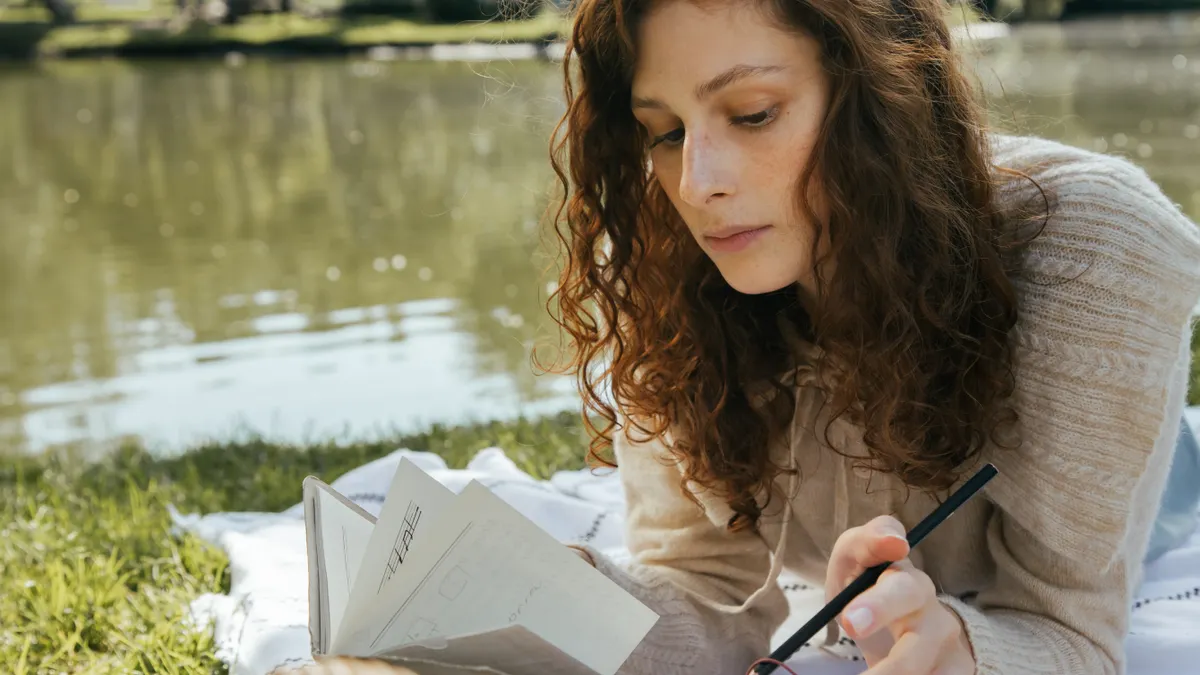 Deep journal prompts for emotional clarity — Woman Writing in Journal