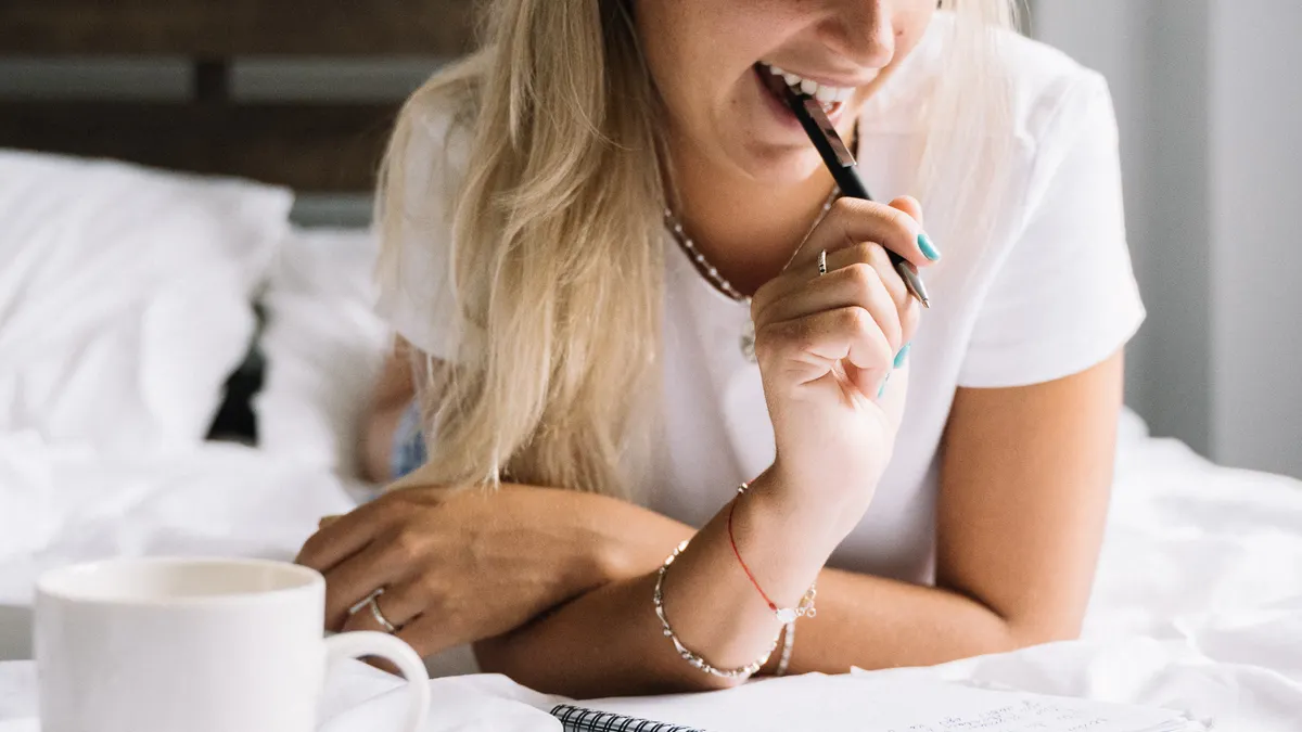 How to journal every day when you have no time — Woman Journaling in Bed