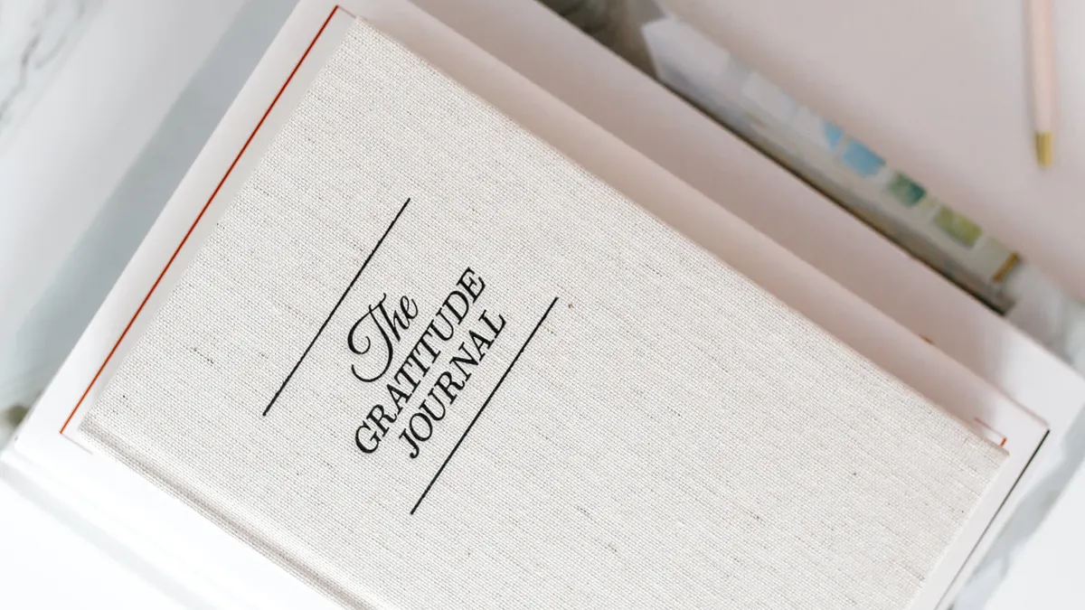 How to make journaling a daily habit — Elegant Gratitude Journal with Coffee on Desk