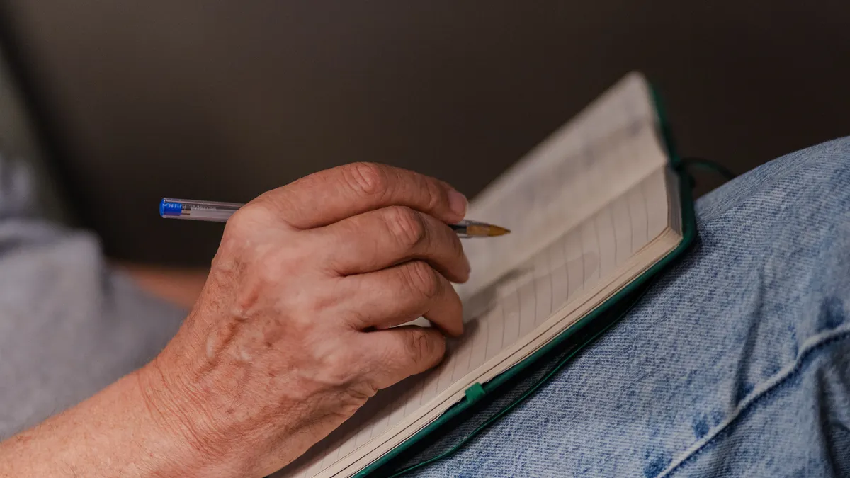 Journaling for self-reflection: what to focus on in each entry — Adult Writing Notes in Journal at Home